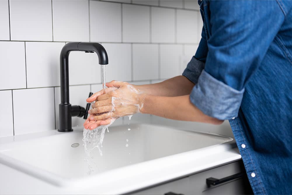 Person with OCD washing hands