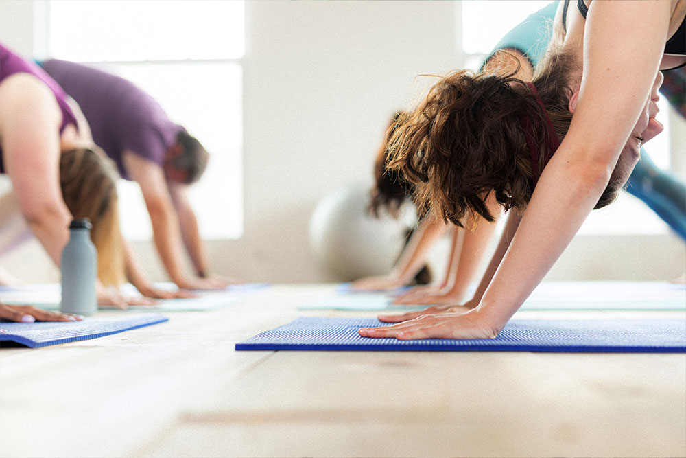 Strength-training Group of people doing yoga in a studio.