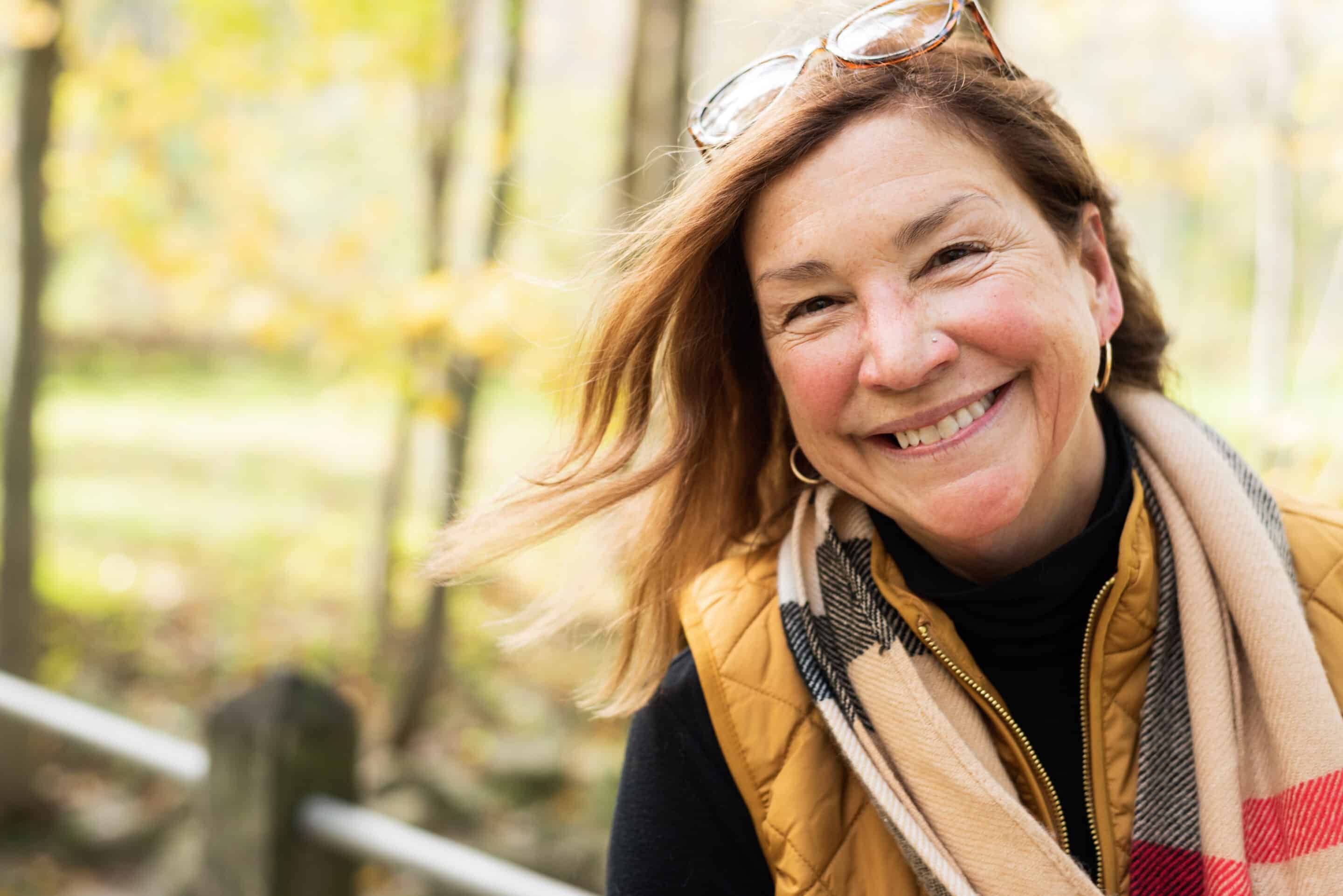 Middle aged woman smiling in autumn