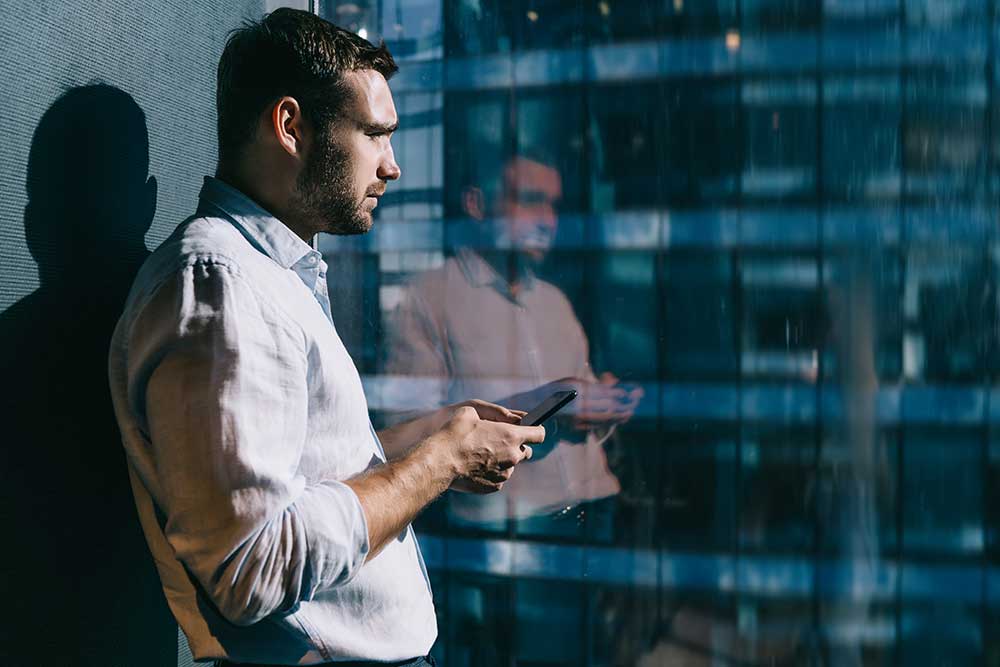 mens-health-awareness-06.26 Male employee deep in thought looking out of window