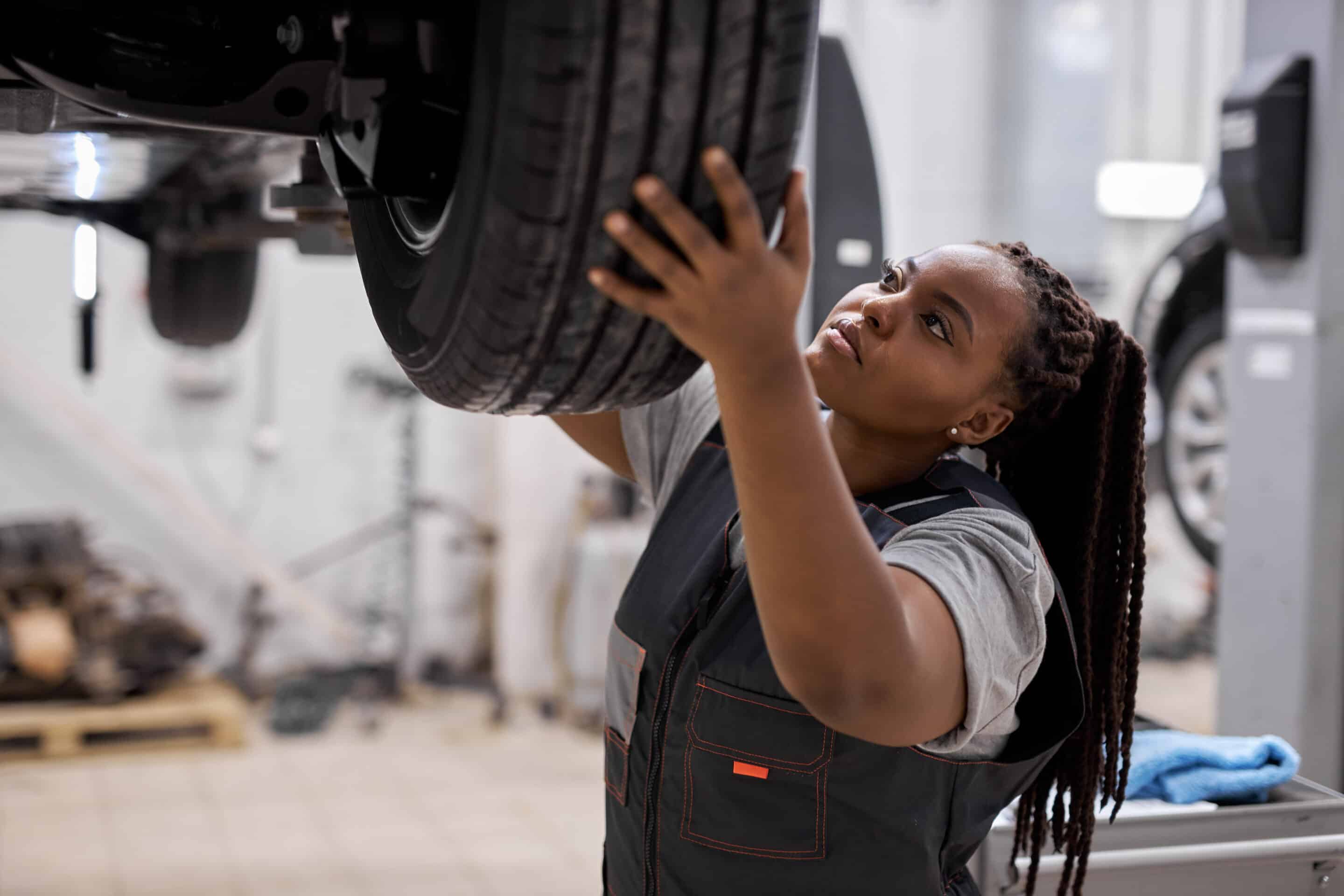 Protecting MSK Mechanic adjusting the tire at repair garage