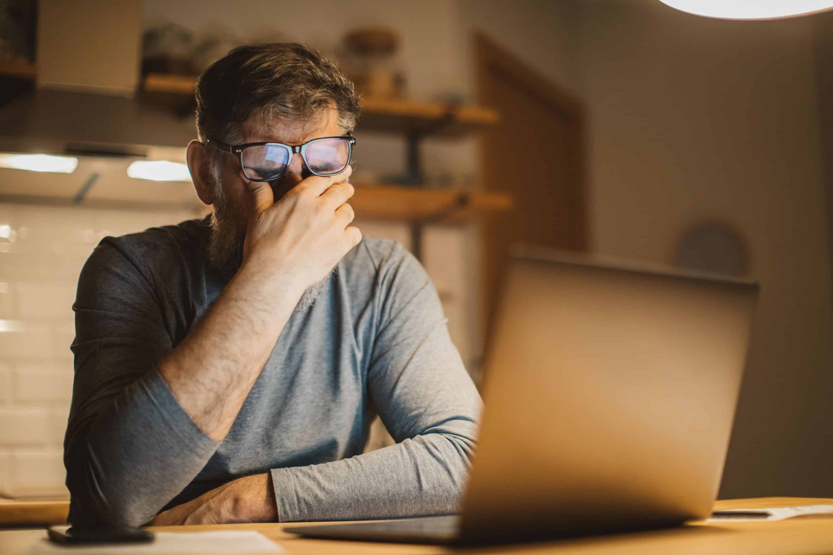 iStock-1217126429-min Man rubbing his eyes as tired and stressed