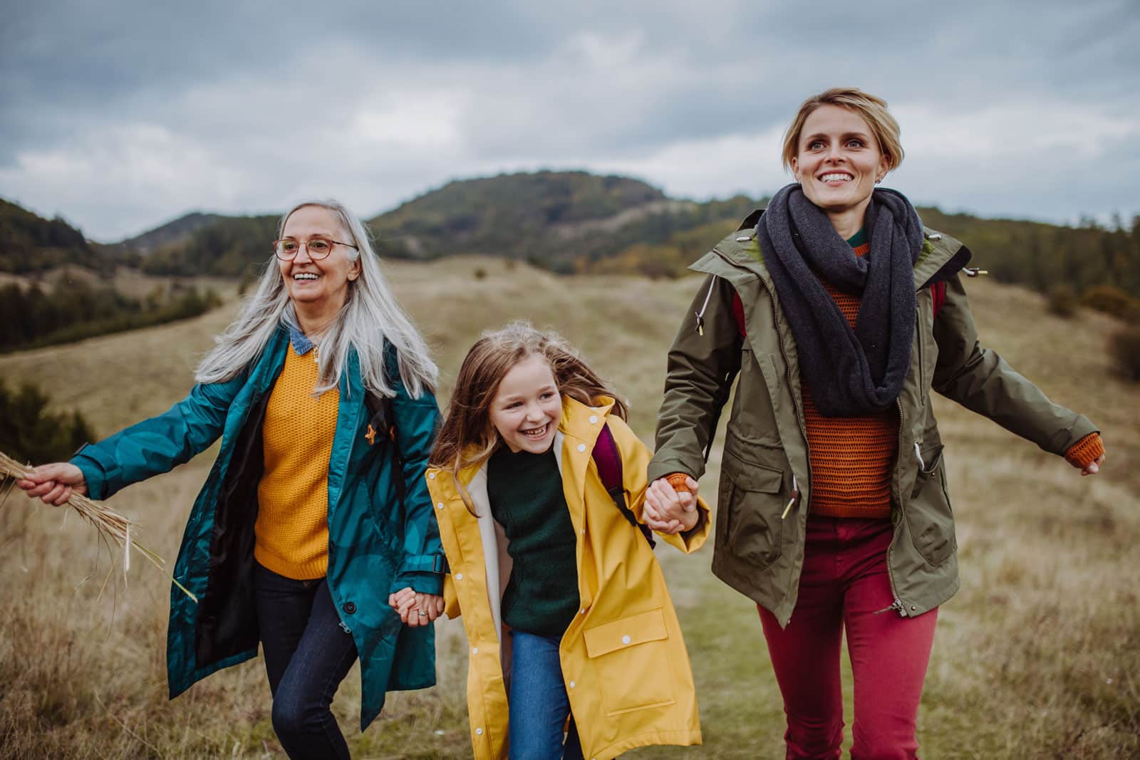 An image showing three generations of females walking together, highlighting duel-caring responsibilities.